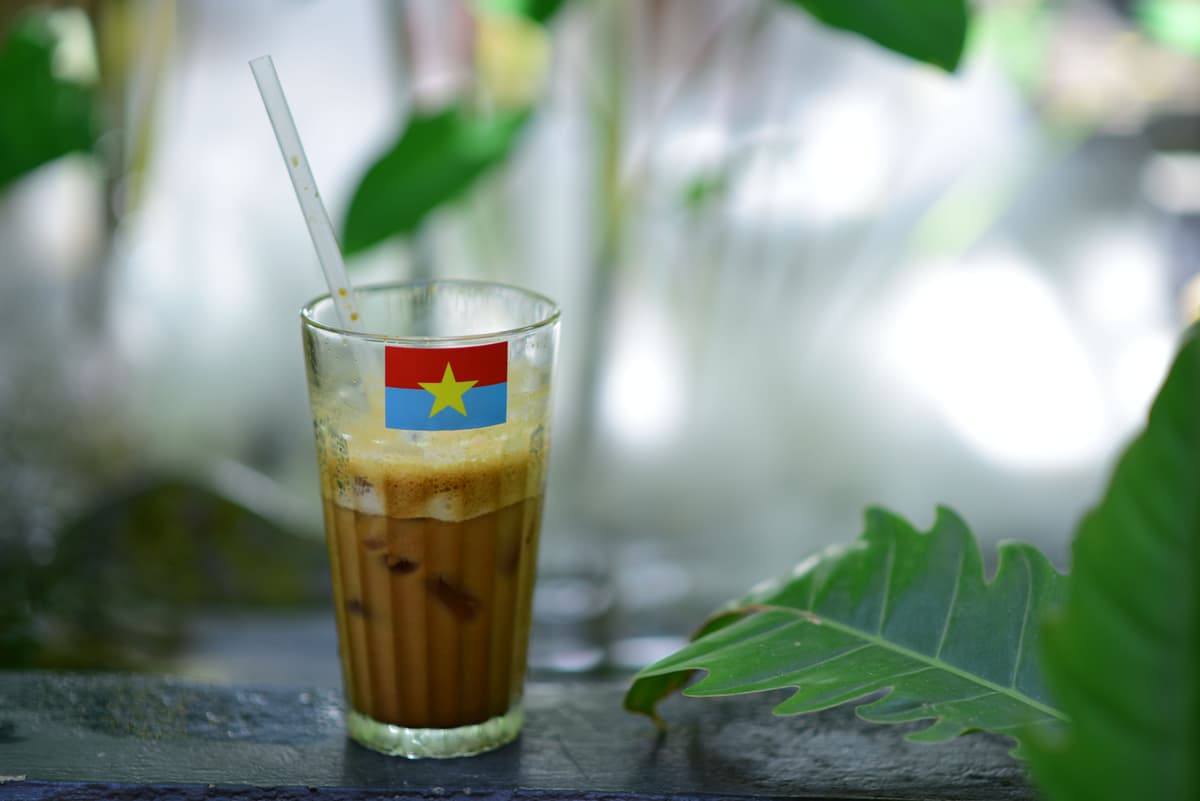 Traditional Vietnamese egg coffee in a small glass bowl of warm water