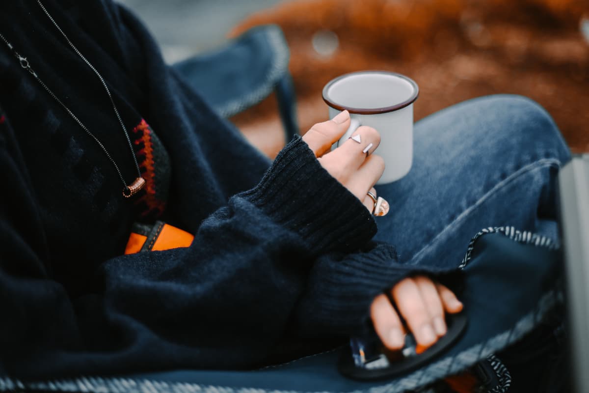 Hands holding a warm ceramic mug